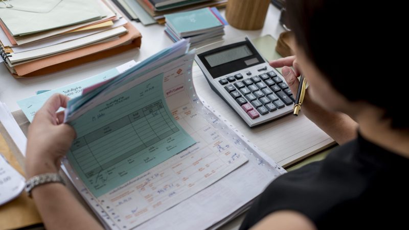 adult-asian-woman-working-on-payment-bills-account-PYDY7G5-min